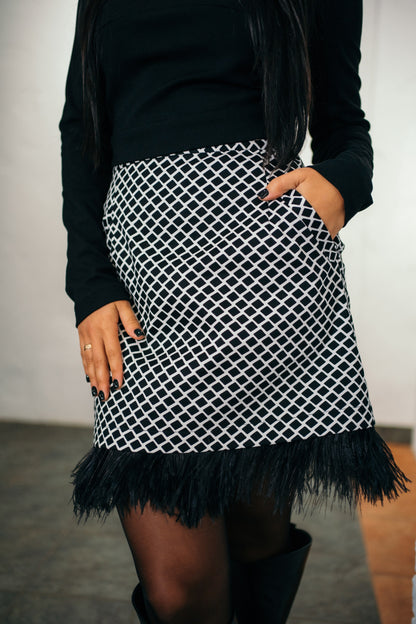 beautiful black haired lady in a black top nad black and white feather skirt - this is a two piece dress, that can be split into top and skirt