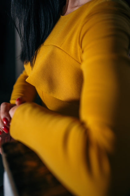 yellow top, red nails