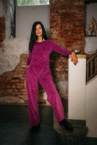 beautiful black haired woman in a magenta jumpsuit