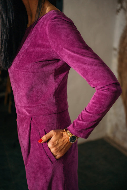 beautiful black haired woman in a magenta jumpsuit