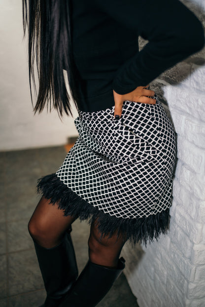 beautiful black haired lady in a black top nad black and white feather skirt - this is a two piece dress, that can be split into top and skirt