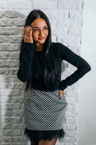 beautiful black haired lady in a black top nad black and white feather skirt - this is a two piece dress, that can be split into top and skirt