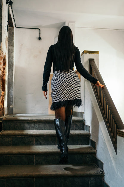 beautiful black haired lady in a black top nad black and white feather skirt - this is a two piece dress, that can be split into top and skirt