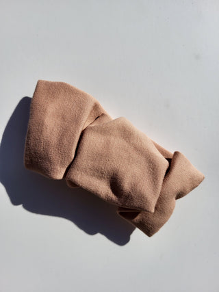 beige hair clip on white table