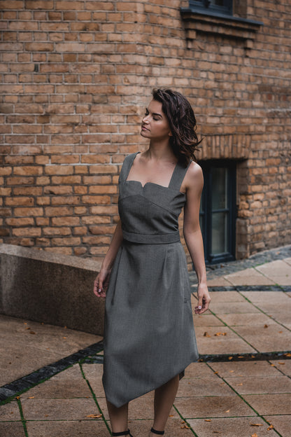 beautiful brunette on the streets in a gray two piece office dress - a corset top and a triangle skirt