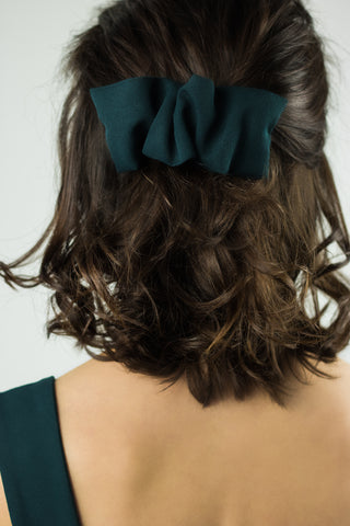 emerald green hair clip pinned in the hair
